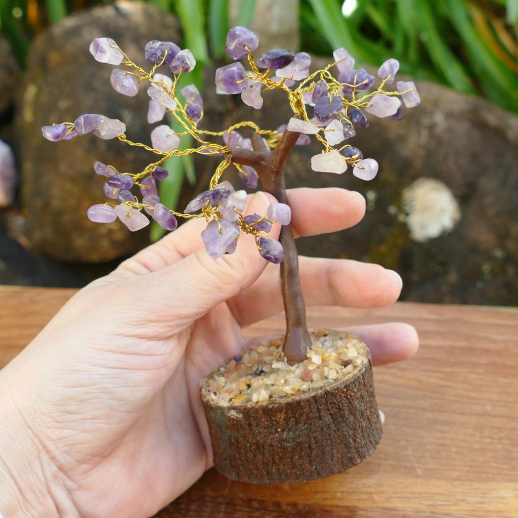 Amethyst crystal gem tree on natural wood base