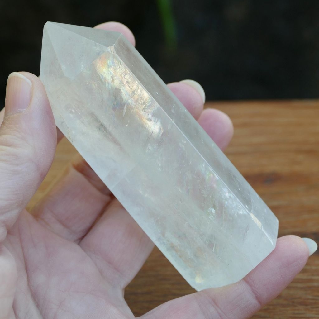 Polished Calcite crystal point tower with natural rainbow inclusions and translucent finish