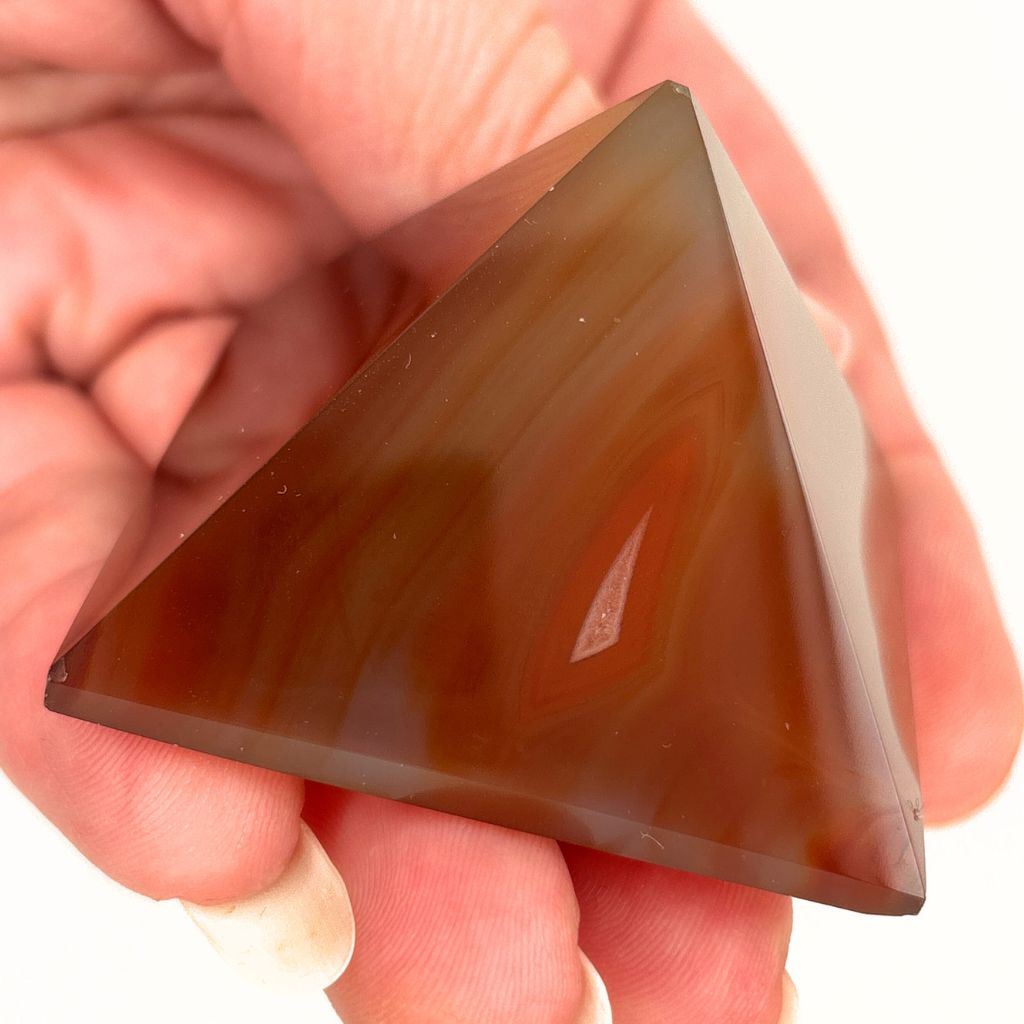 Polished Carnelian crystal pyramid with natural orange banding