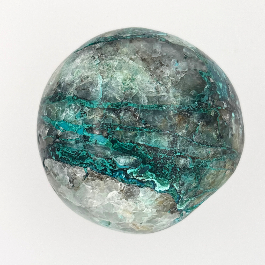 Chrysocolla in quartz crystal sphere from Peru