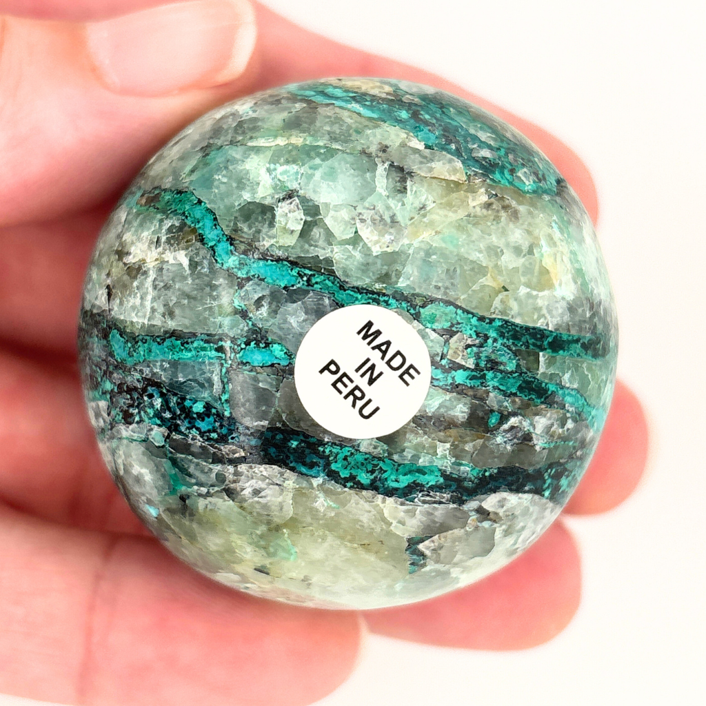 Chrysocolla in quartz crystal sphere from Peru