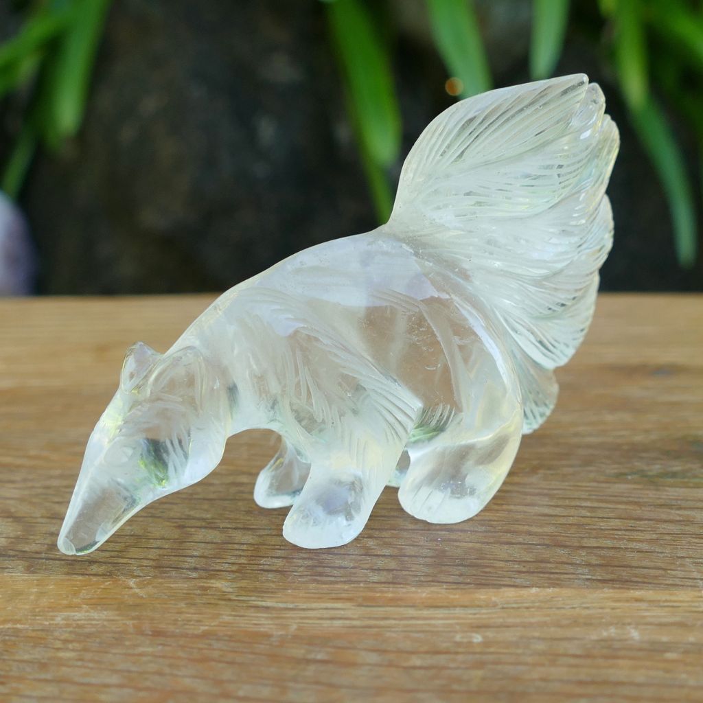 Hand carved Clear Quartz Anteater crystal carving with detailed tail and natural transparent quartz features.