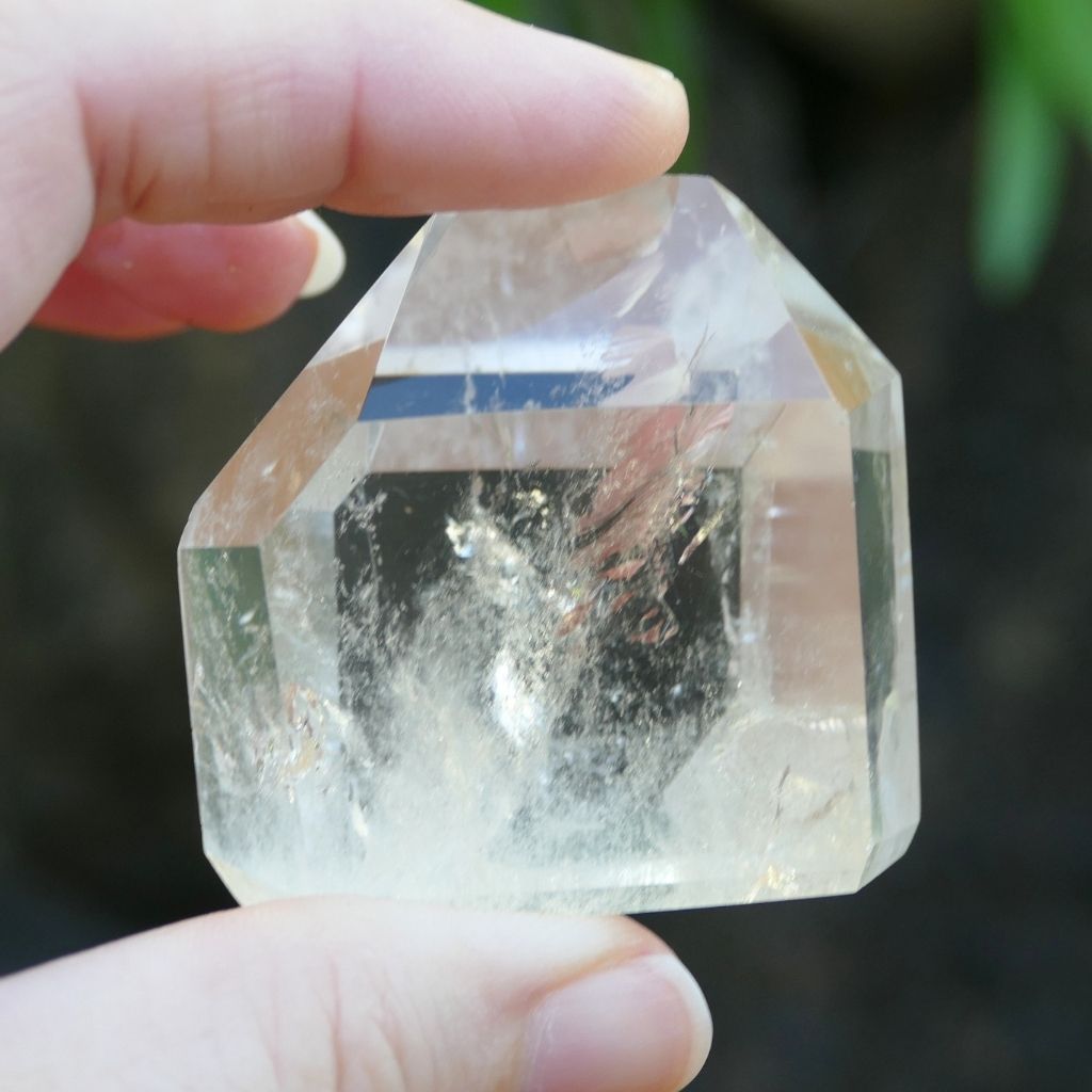 Polished Clear Quartz crystal point with natural inclusions and generator shape