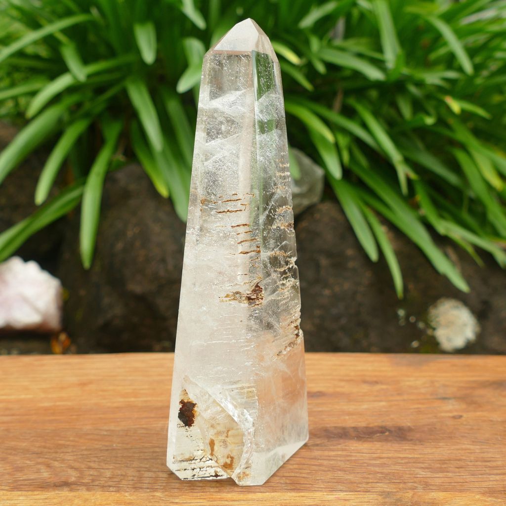 Natural Clear Quartz Crystal Point with stunning internal inclusions and polished finish.