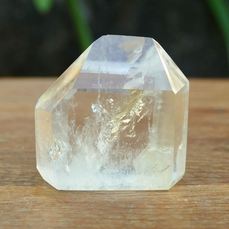 Polished Clear Quartz crystal point with natural inclusions and generator shape