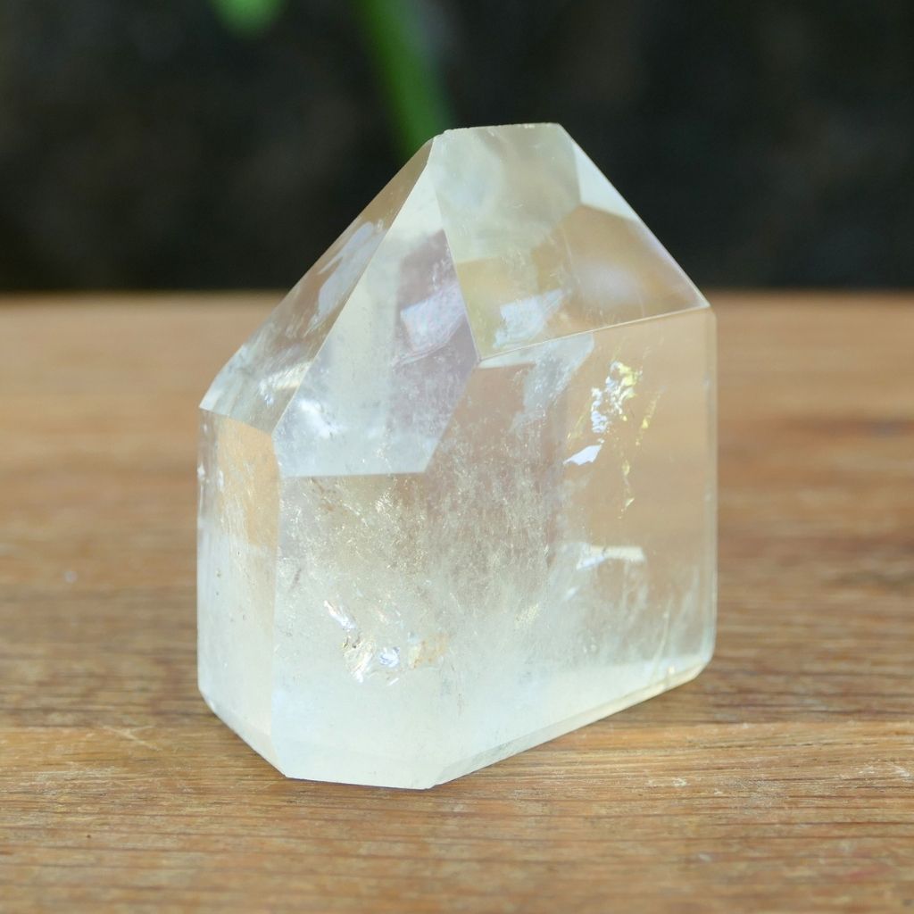 Polished Clear Quartz crystal point with natural inclusions and generator shape