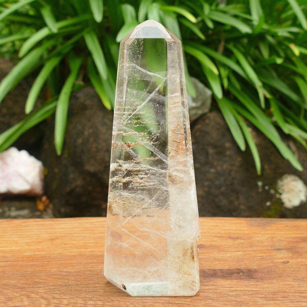 Natural Clear Quartz Crystal Point with stunning internal inclusions and polished finish.