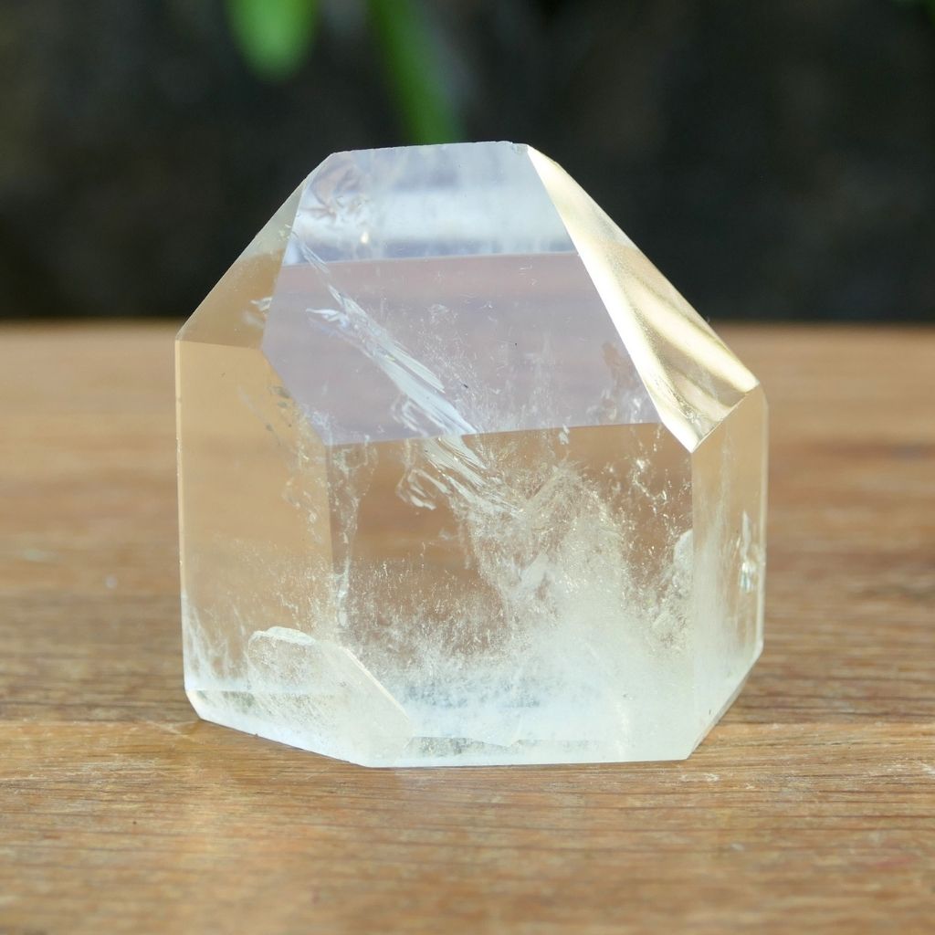 Polished Clear Quartz crystal point with natural inclusions and generator shape