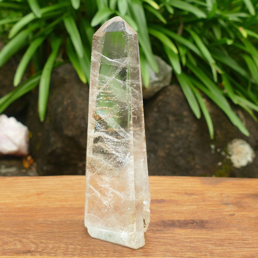 Natural Clear Quartz Crystal Point with stunning internal inclusions and polished finish.