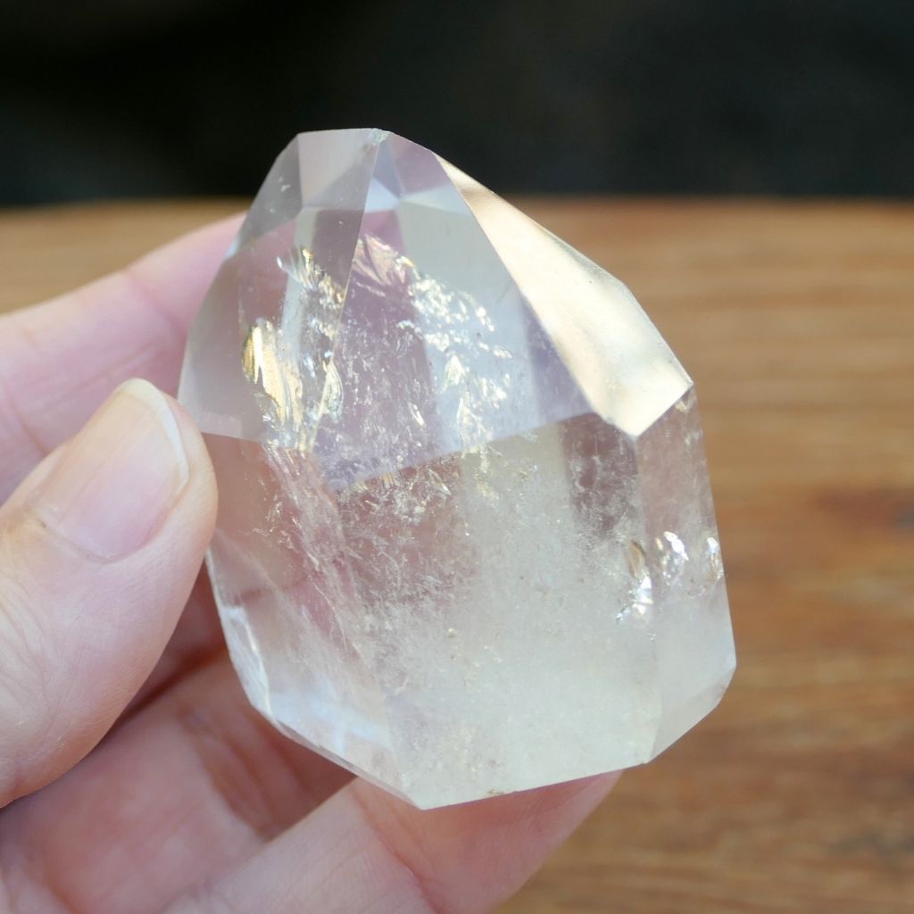 Polished Clear Quartz crystal point with natural inclusions and generator shape