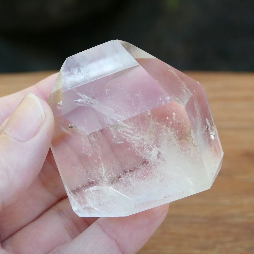 Polished Clear Quartz crystal point with natural inclusions and generator shape