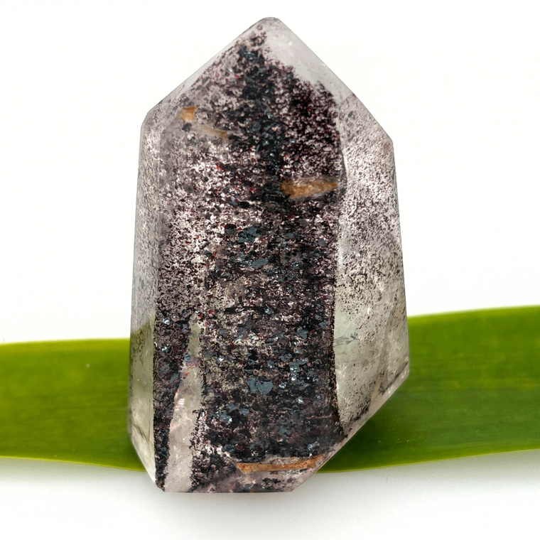 clear quartz point with dark mineral inclusions