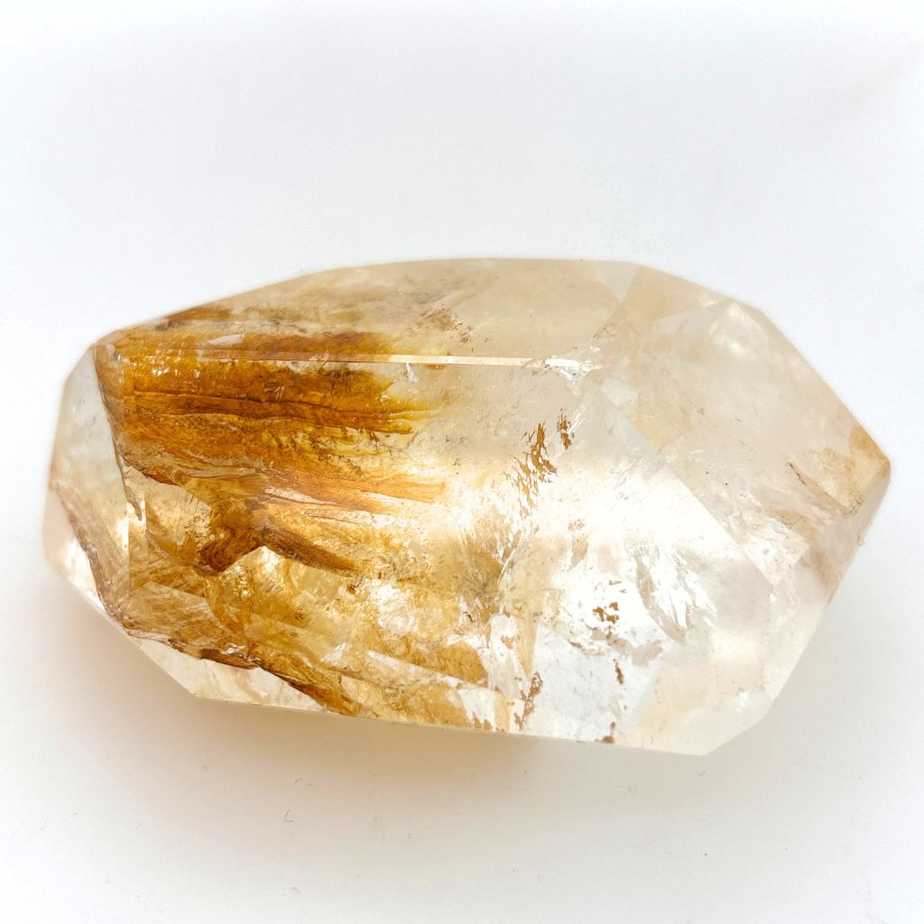Clear Quartz polished freeform with golden brown mineral inclusions 267g