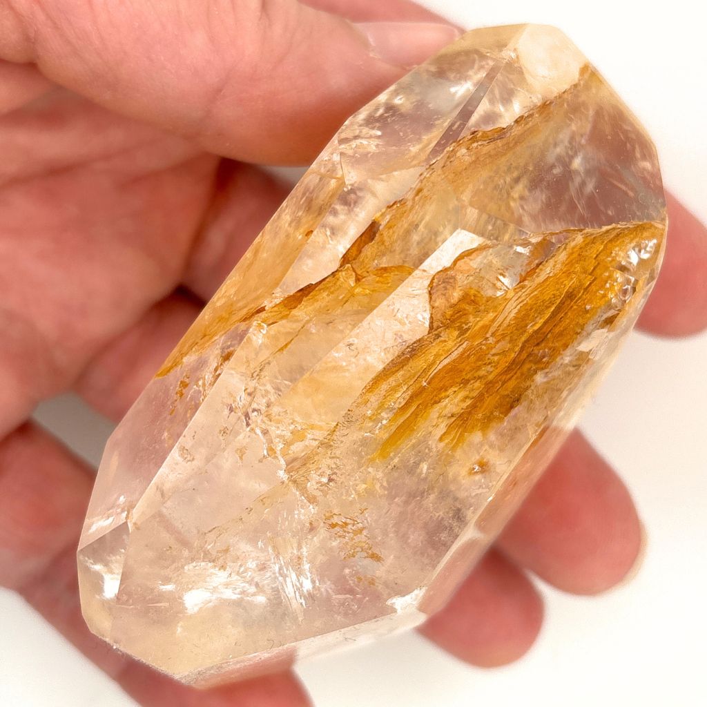 Clear Quartz polished freeform with golden brown mineral inclusions 267g