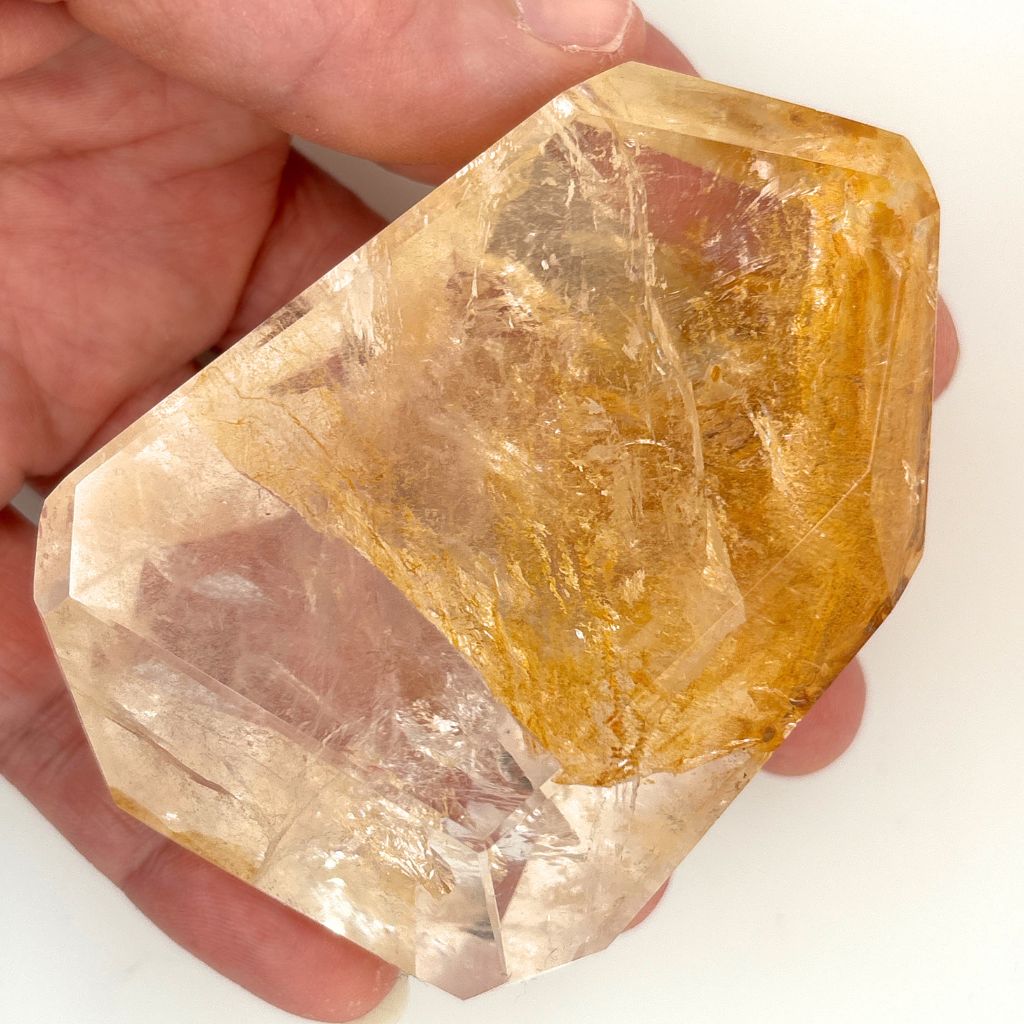 Clear Quartz polished freeform with golden brown mineral inclusions 267g