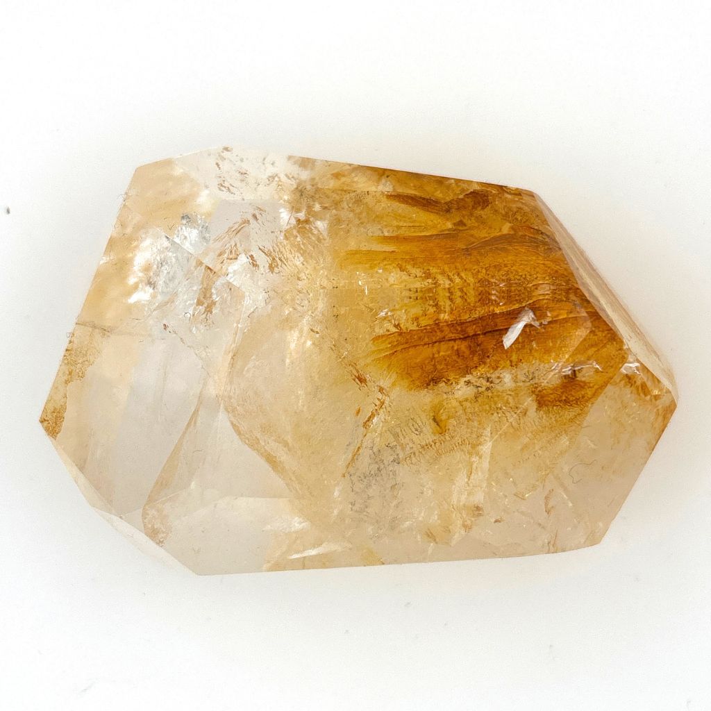 Clear Quartz polished freeform with golden brown mineral inclusions 267g