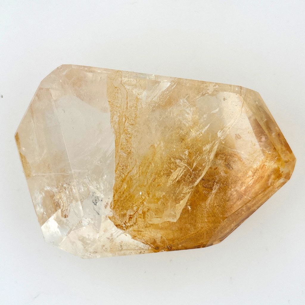Clear Quartz polished freeform with golden brown mineral inclusions 267g