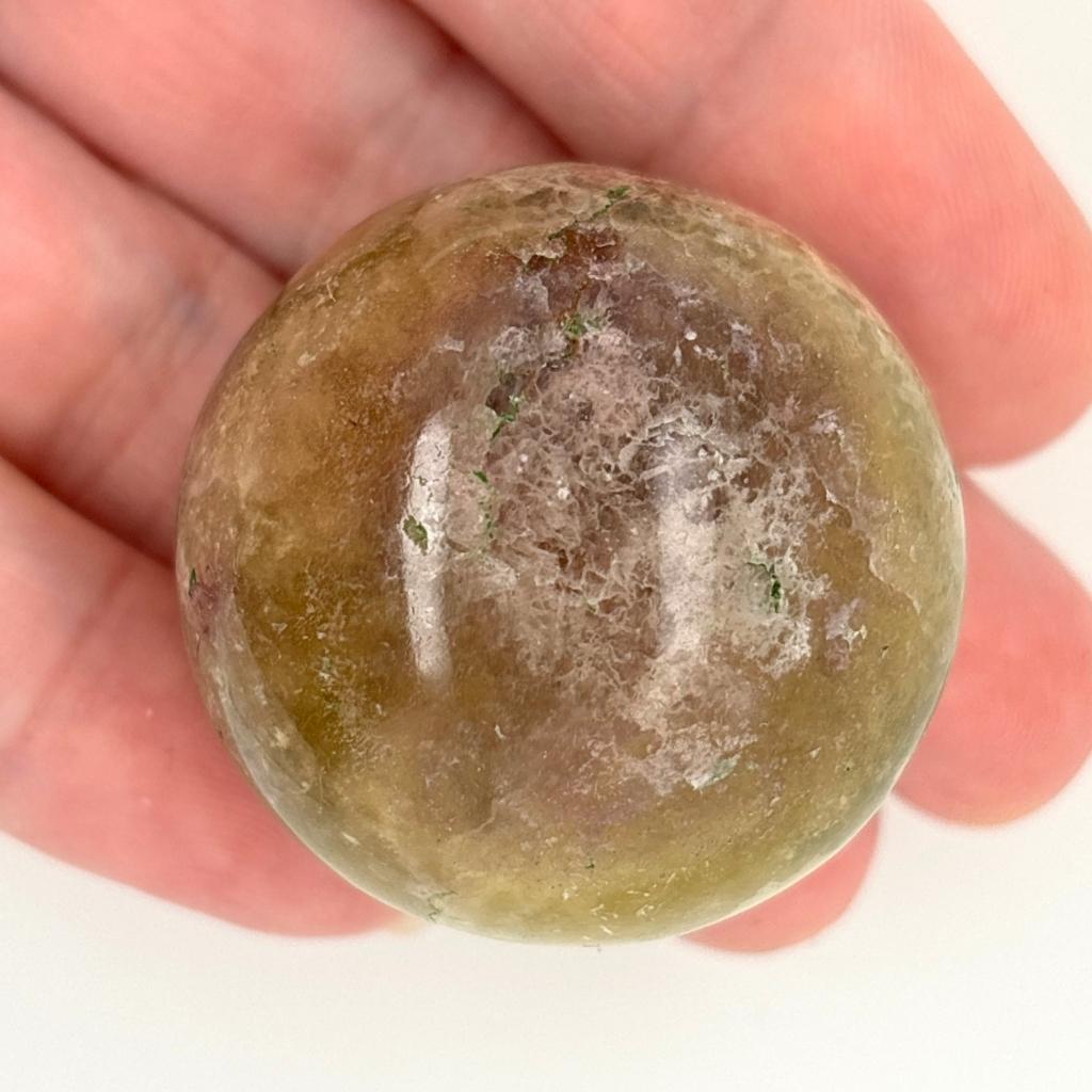 Polished Fluorite crystal sphere with green, gold and lavender natural banding and flat cut base for display