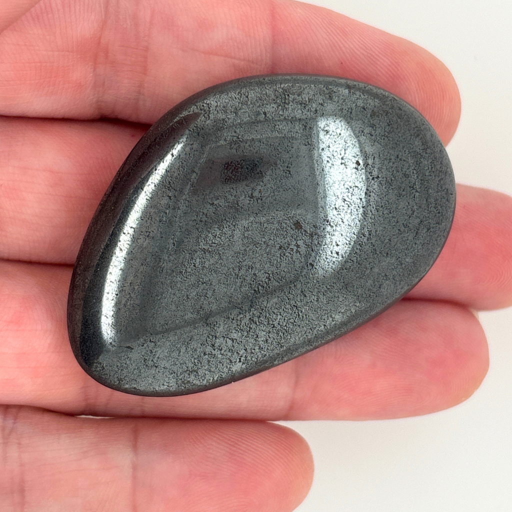 Polished hematite palm stone metallic grey grounding crystal