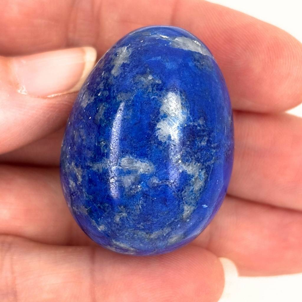 Polished Lapis Lazuli crystal egg with deep blue and white natural patterns