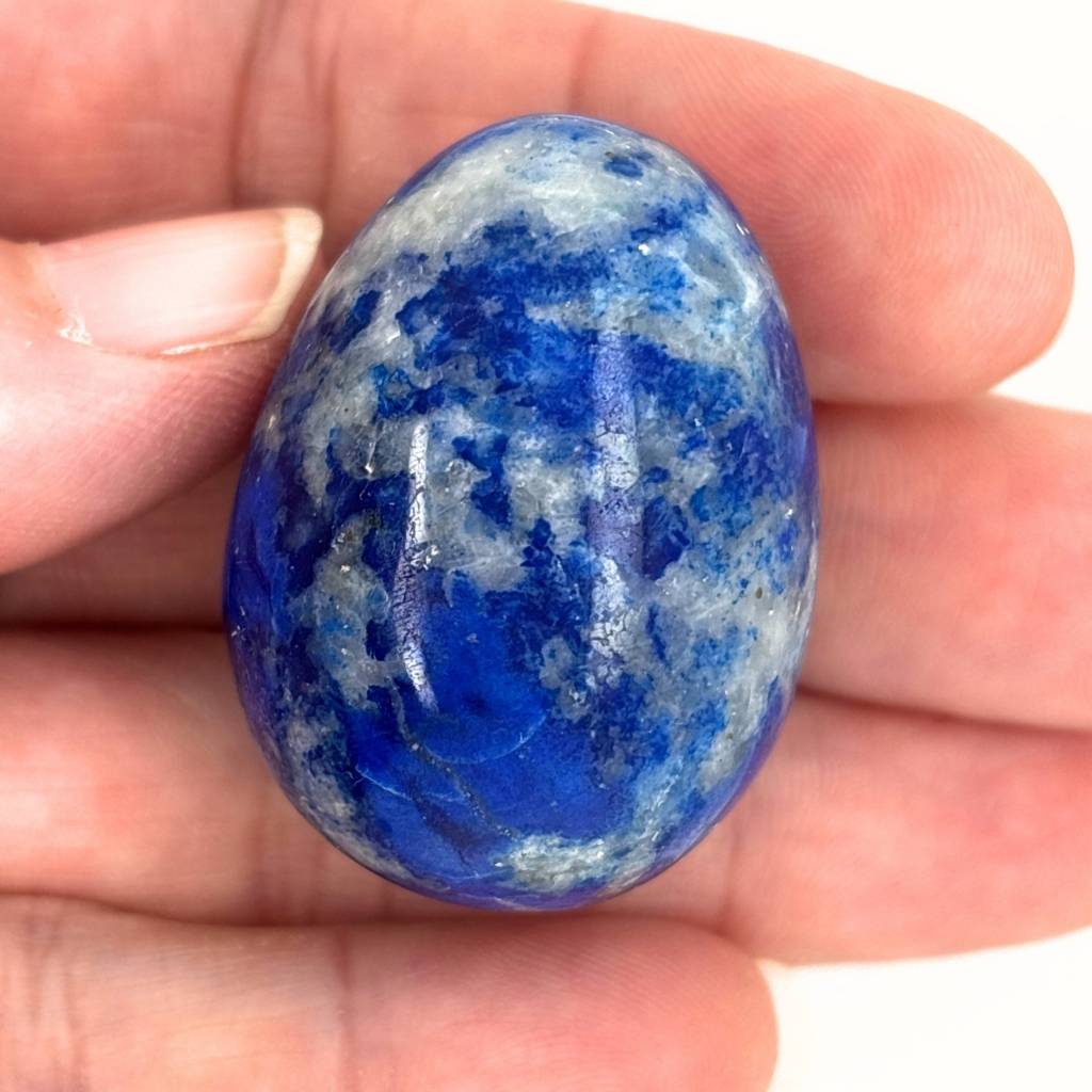 Polished Lapis Lazuli crystal egg with deep blue and white natural patterns