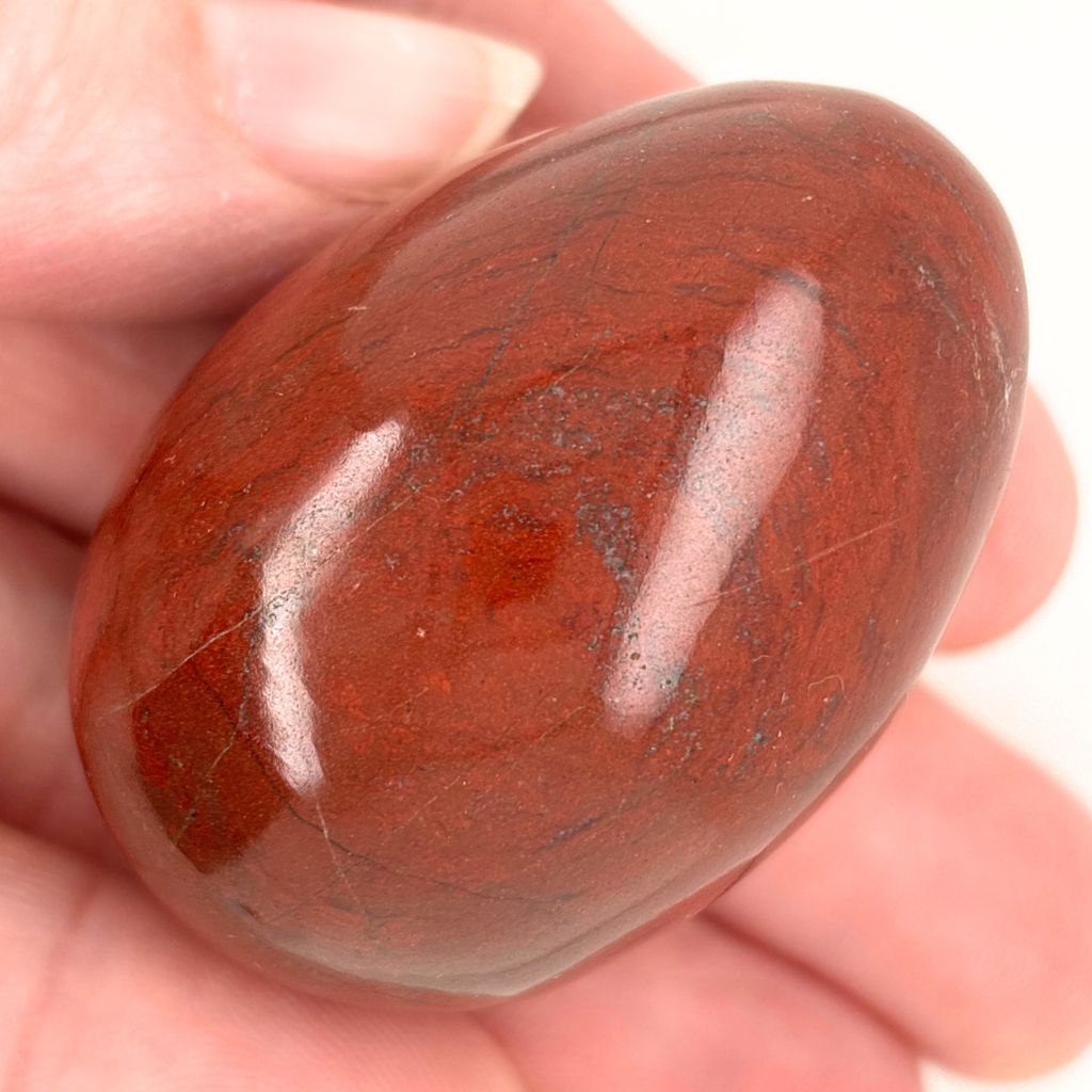 Natural Red Jasper crystal egg with deep red tones and dark markings