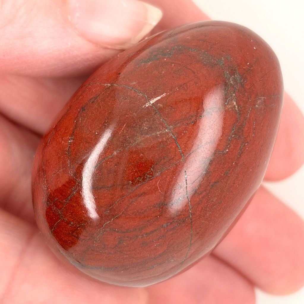 Natural Red Jasper crystal egg with deep red tones and dark markings