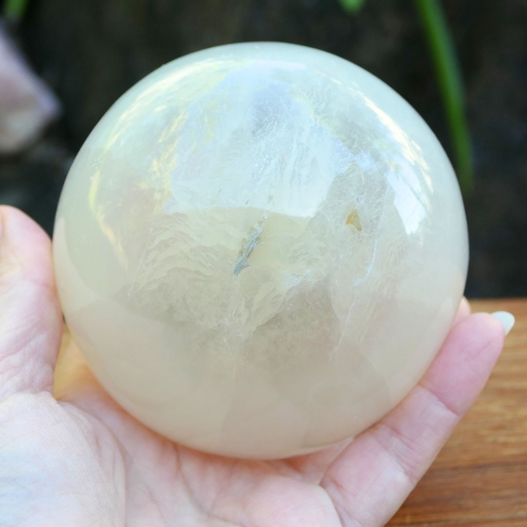 Polished white Selenite crystal sphere with soft glowing finish