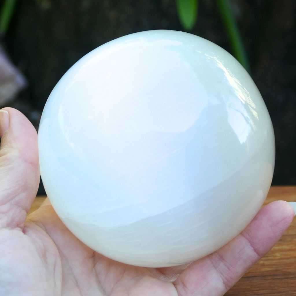 Polished white Selenite crystal sphere with soft glowing finish