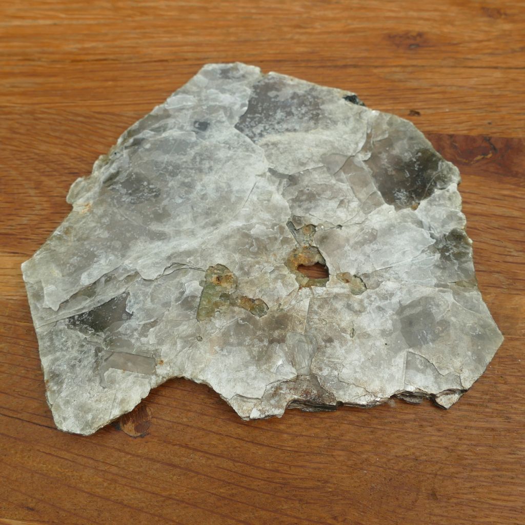 Natural Silver Muscovite Mica display specimen with layered sheet formation weighing 140g, ideal for crystal collectors and home décor.